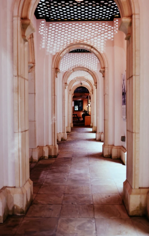 an archway leads into a long hall with pillars