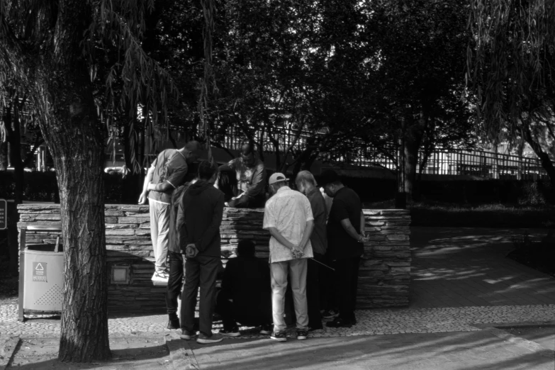 there are people standing around at the park