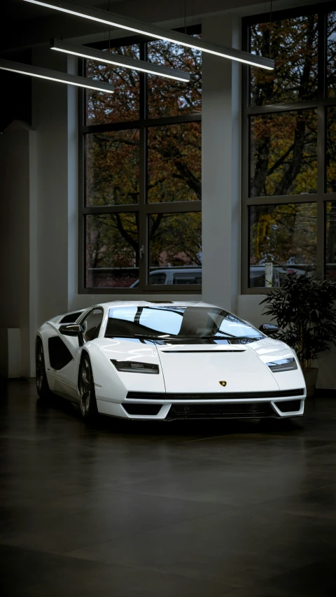 a white car parked inside of an office building