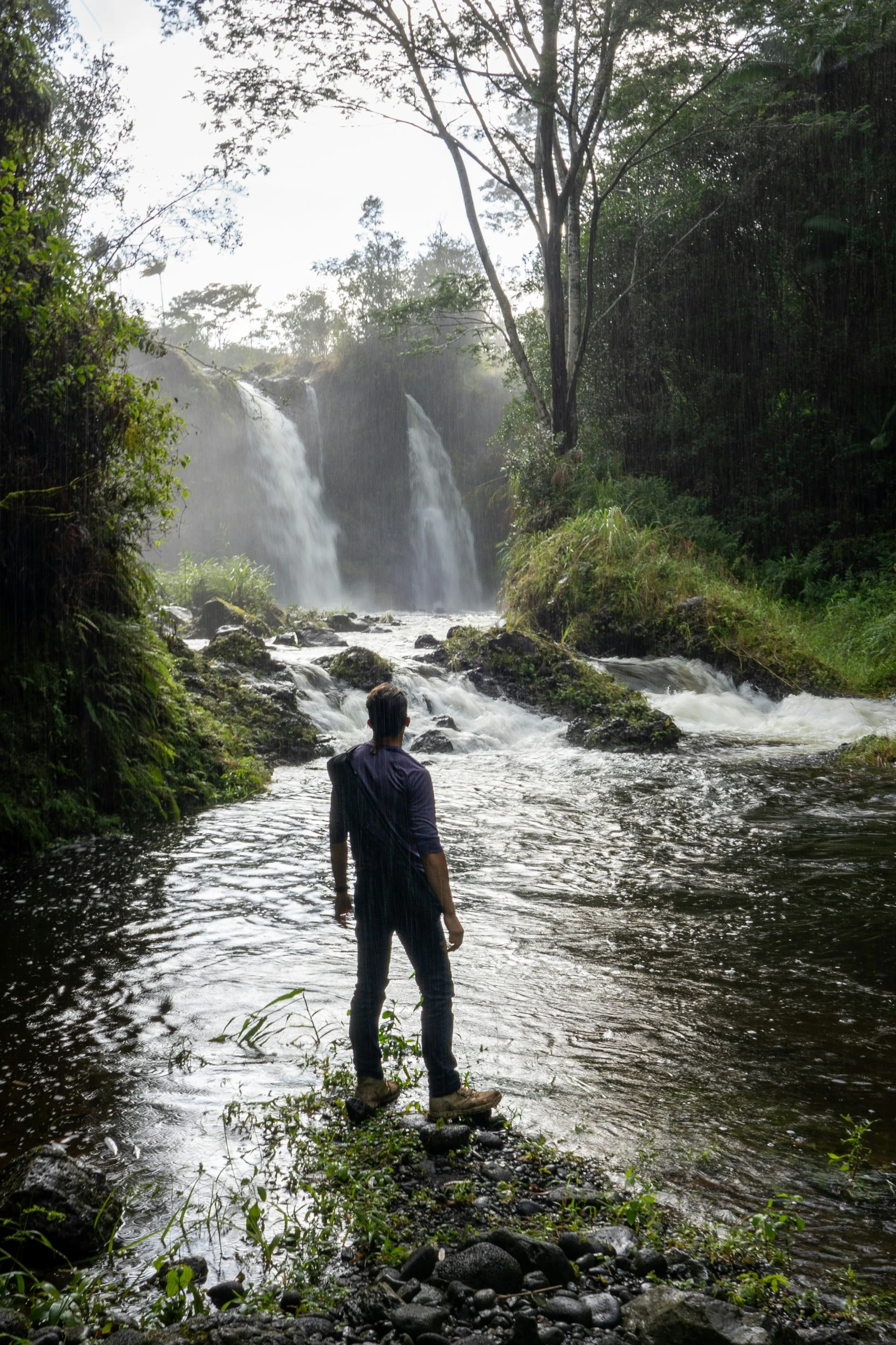 a man standing in the middle of a river