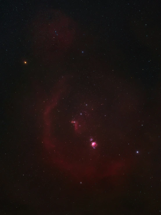 a very large red object with stars in the background