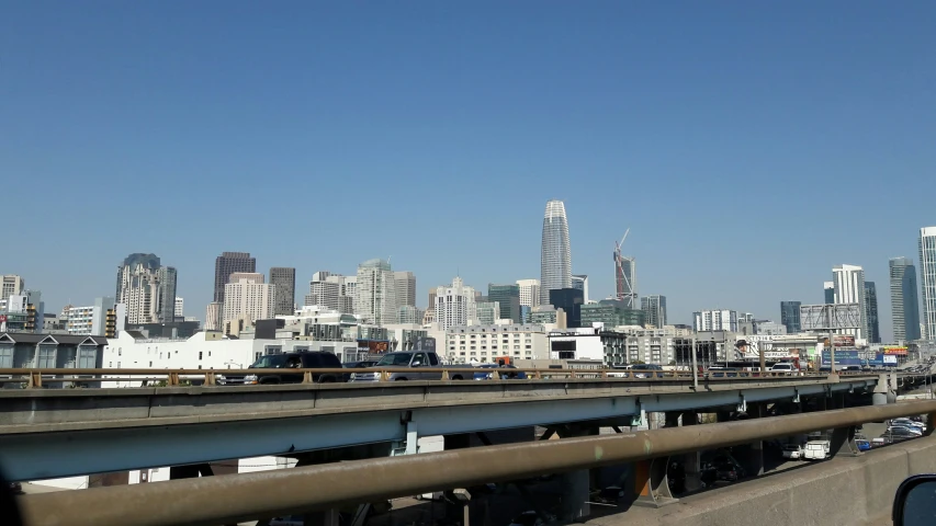 the highway runs through an urban setting with high rise buildings