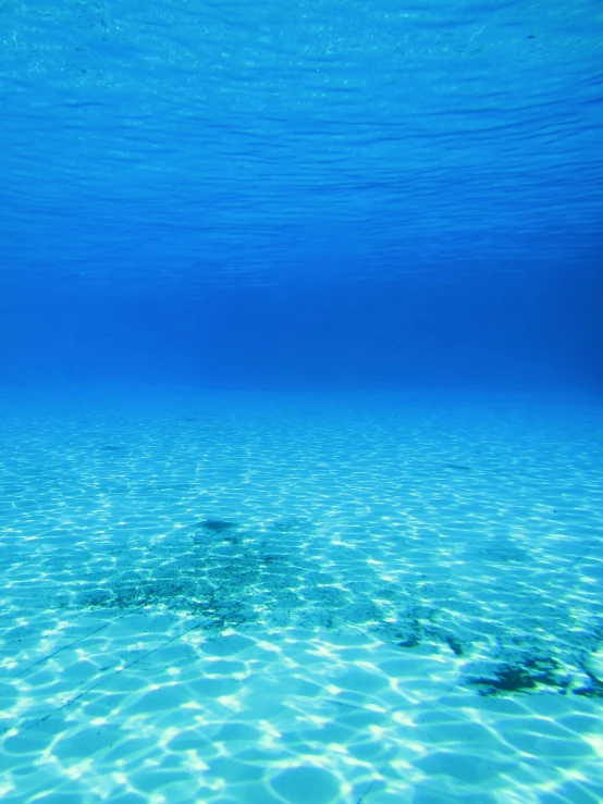 a very bright blue water that is underwater