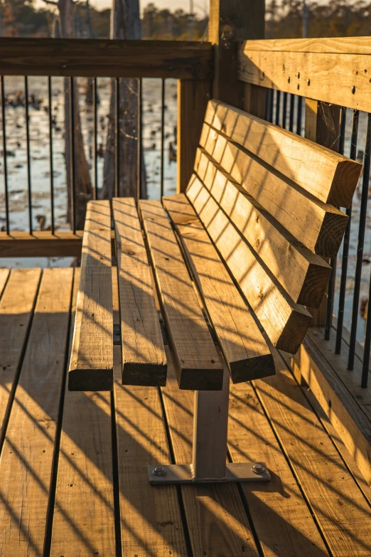 a wooden bench that has been put in the sun