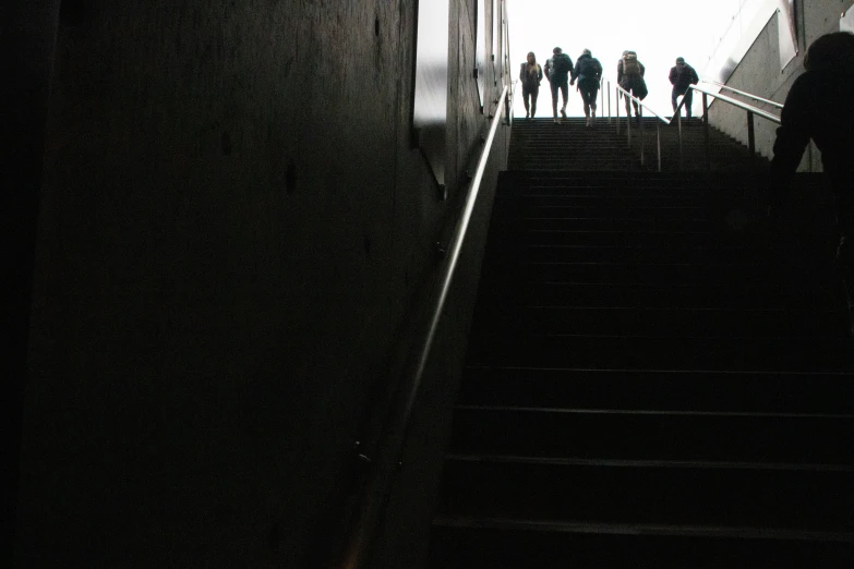 several people on the stairs in the dark