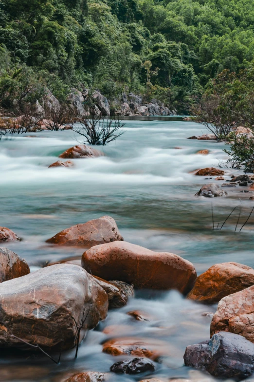 there is a flowing creek near many rocks