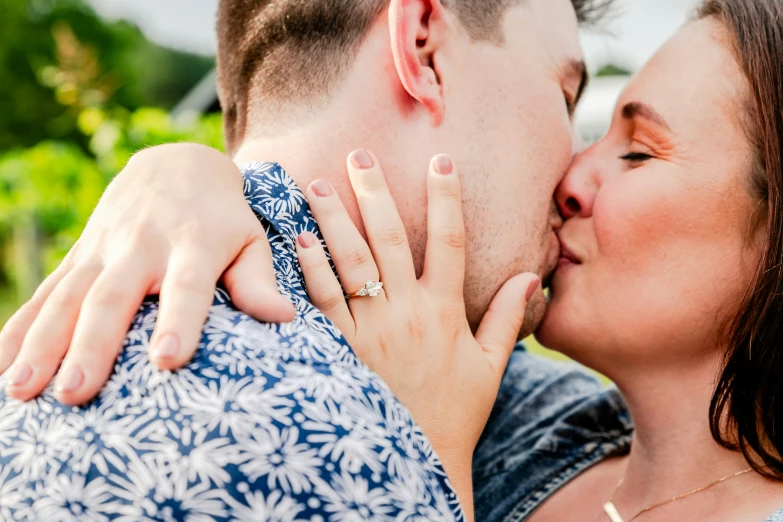 the couple is kissing each other while standing close together