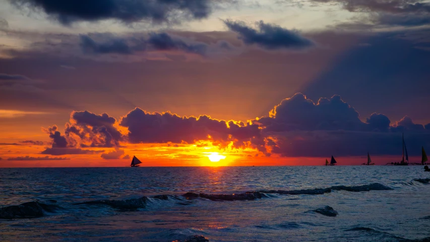 sunset, a sailboat on the horizon of the ocean