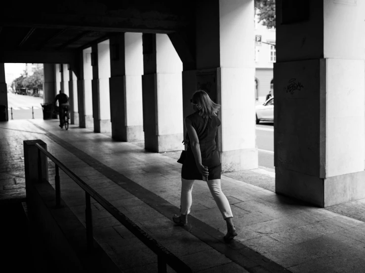 a person walking in front of a building