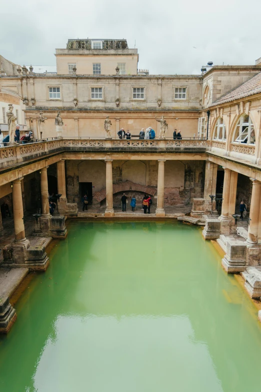 a large water filled pool with people standing on it