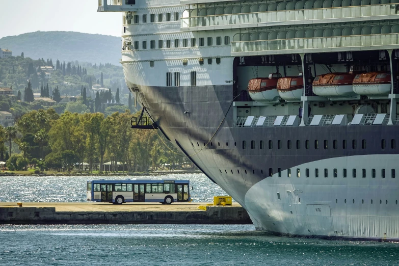 there is a bus that has stopped in front of the ship