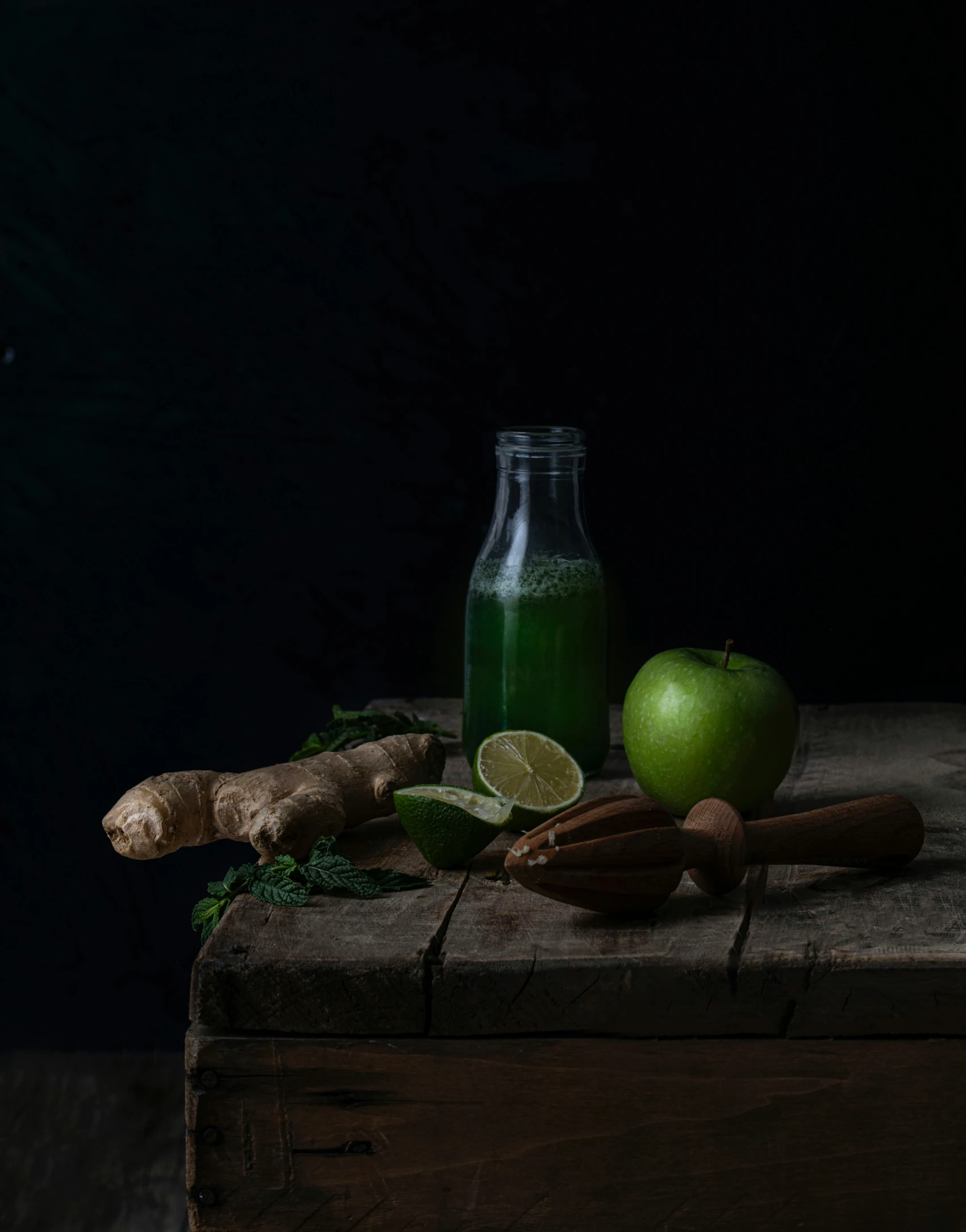 a green apple, cinnamon, lime and ginger sit on a table