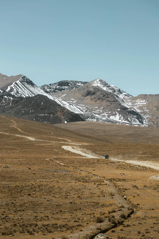 a dirt road is going through the mountains