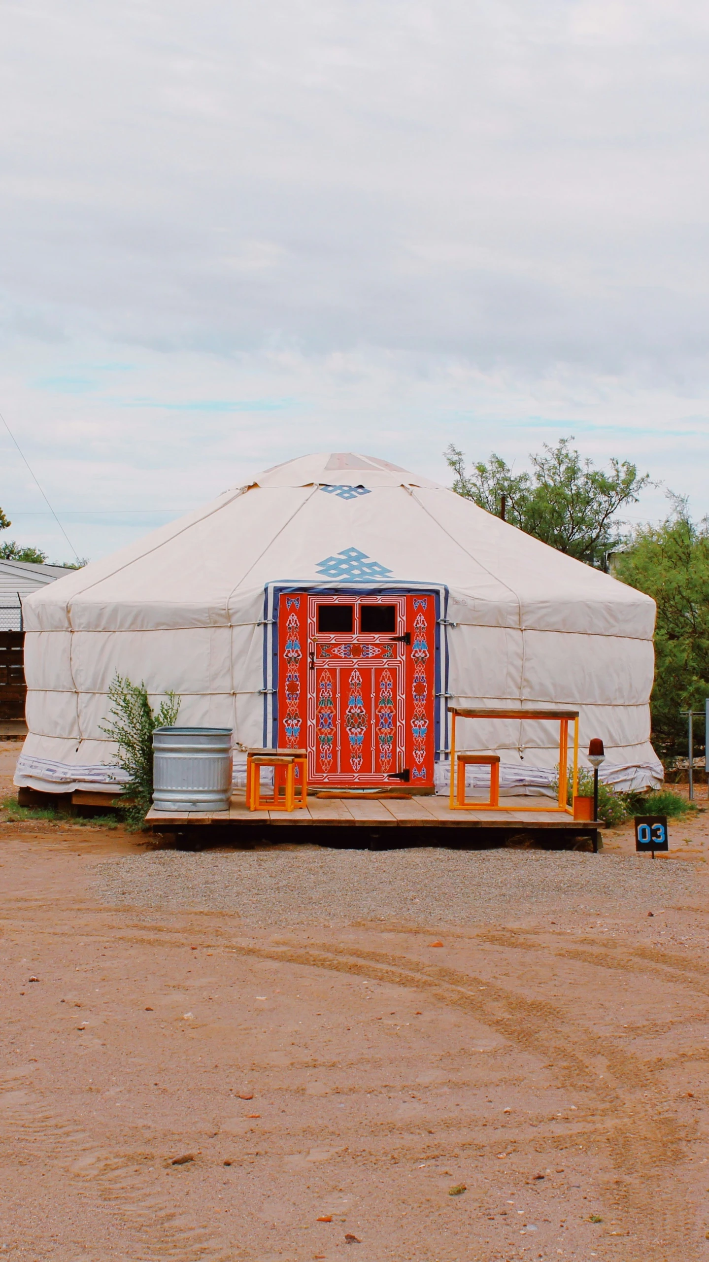 a circus tent sits empty on dirt ground