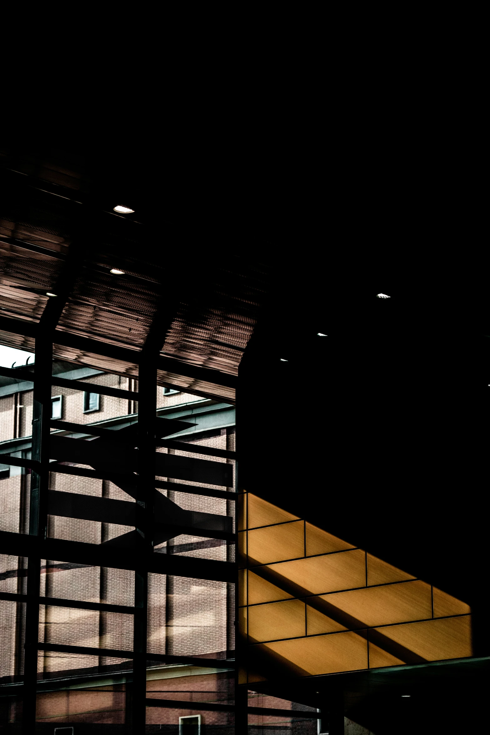 the stair railing and ceiling in a building at night