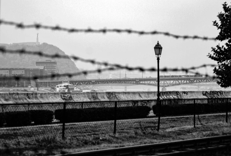 a view from a railroad track looking across the water