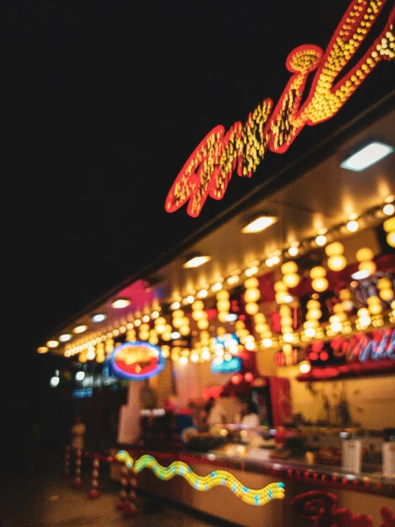 lights are shining on a carnival building at night