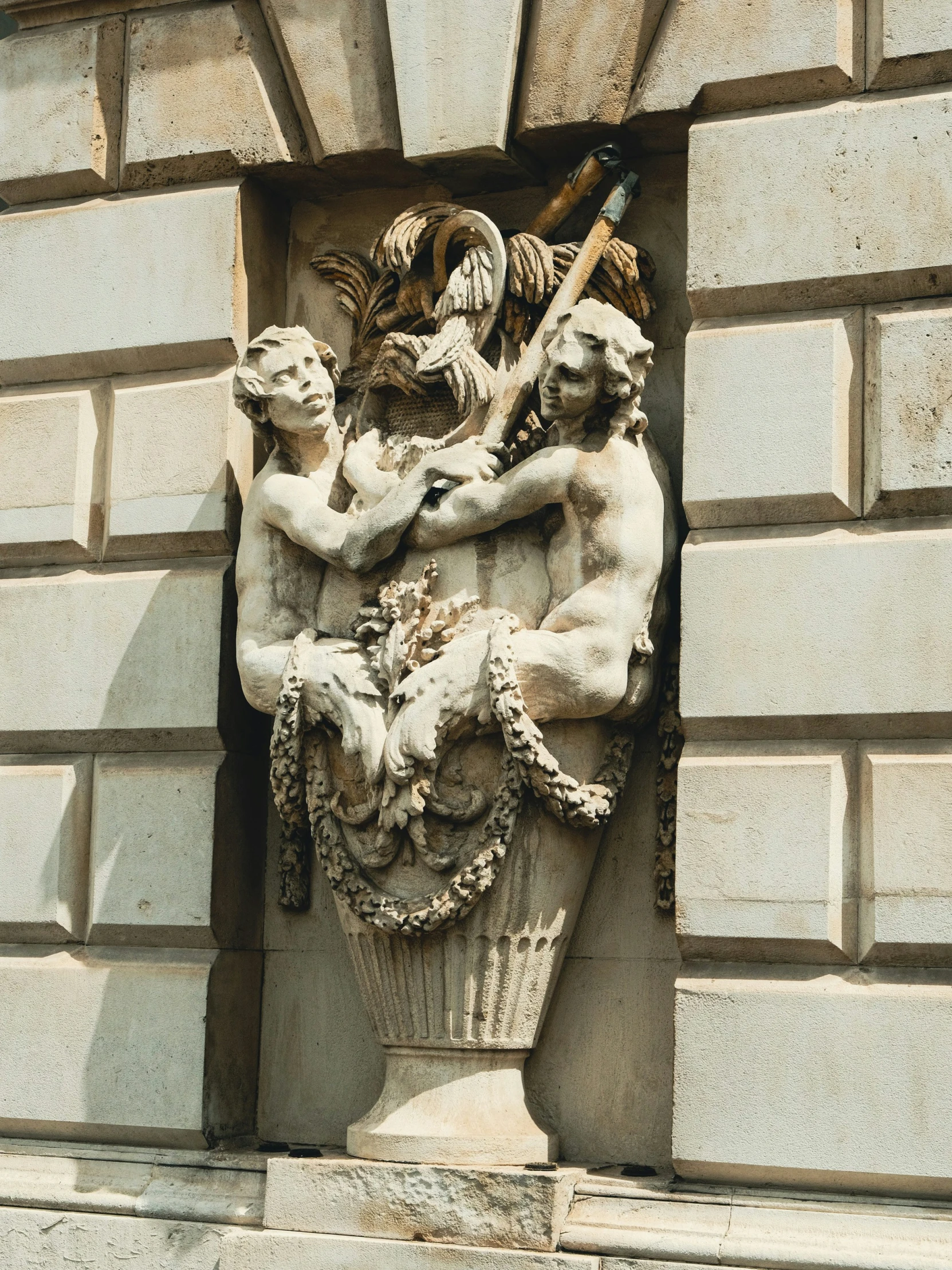 an old statue depicting the four children, including a child, with the head of a demon