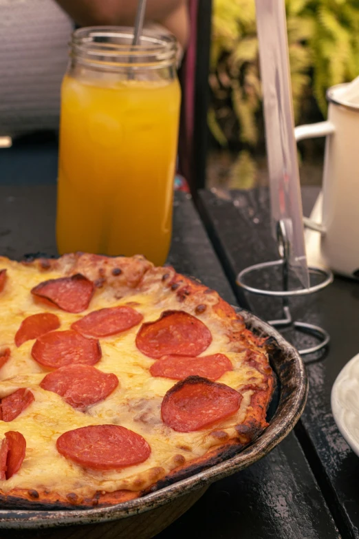 a pizza with pepperoni sits on a table