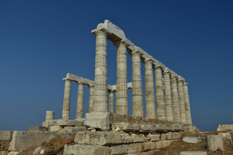 several large pillars are standing on rocks