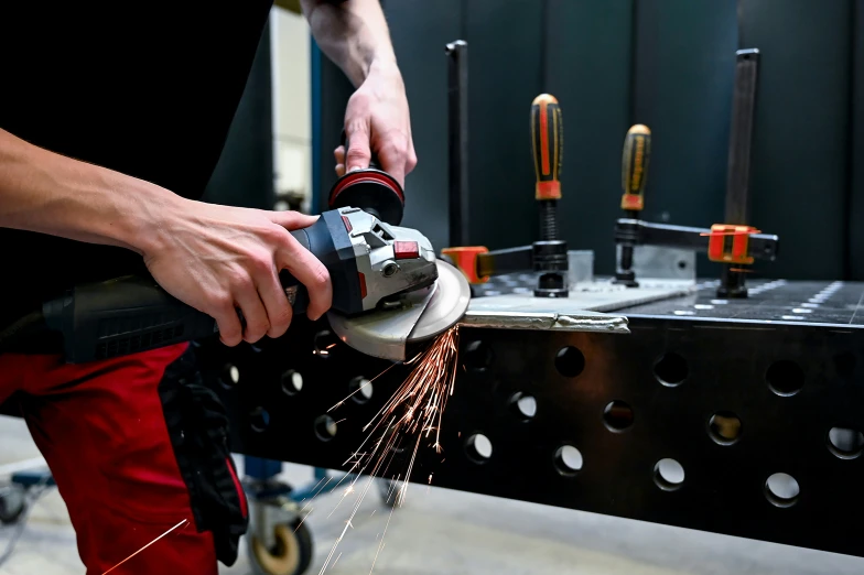 a man working with a circular grinder in his hands