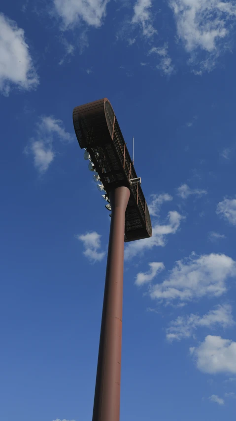 a large radio tower sits atop a tall concrete column