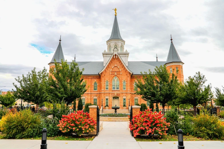 a beautiful orange building with towers and flowers