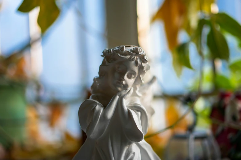 a closeup of a ceramic statue of an angel