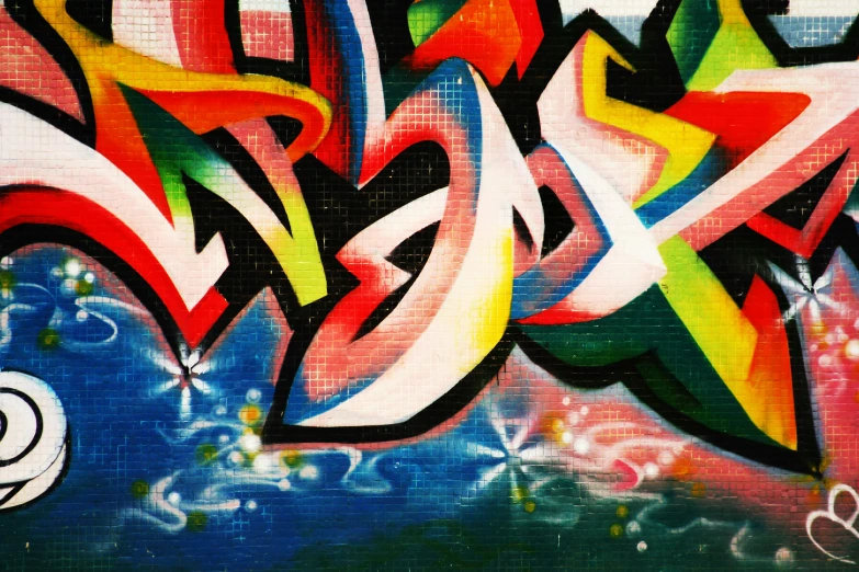 some graffiti on the wall, with multicolored letters