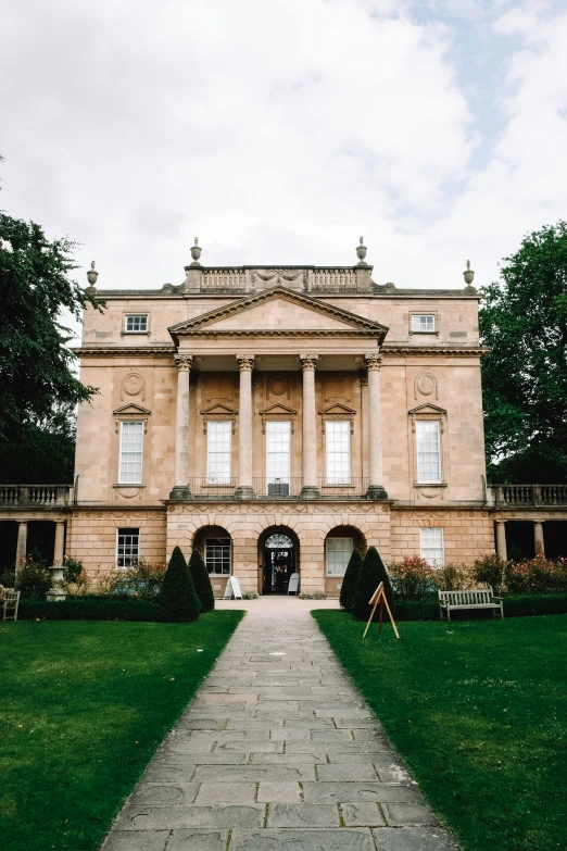 the large building is set in front of a green field