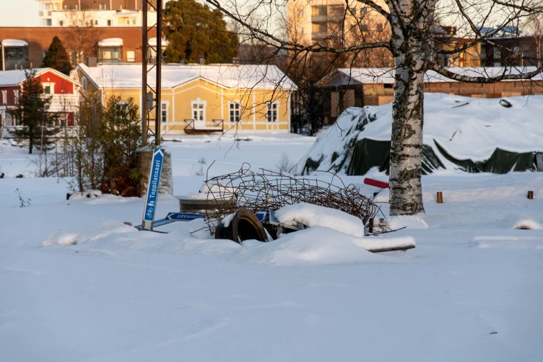 a view of snow and trees in front of buildings