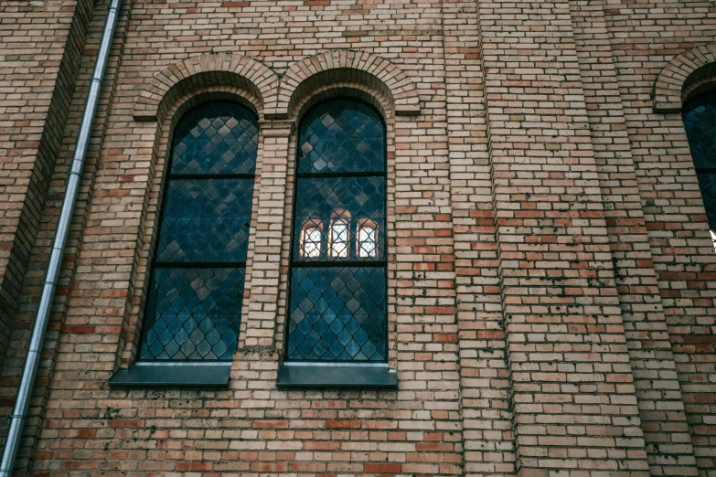 the brick building has two arched windows next to it