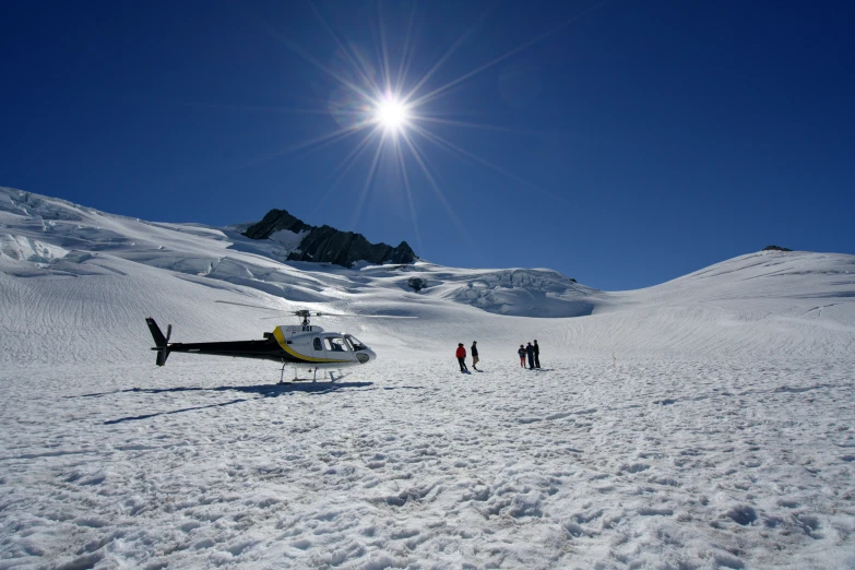 a small aircraft on top of a snow covered slope