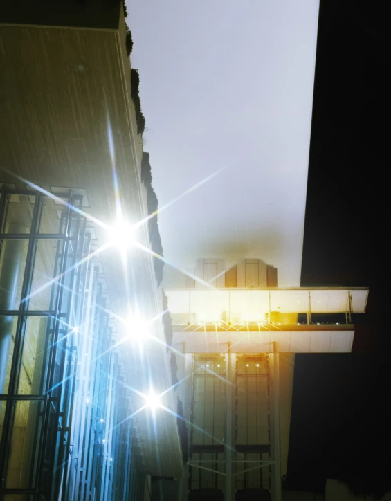 light streaks are shining in front of some buildings