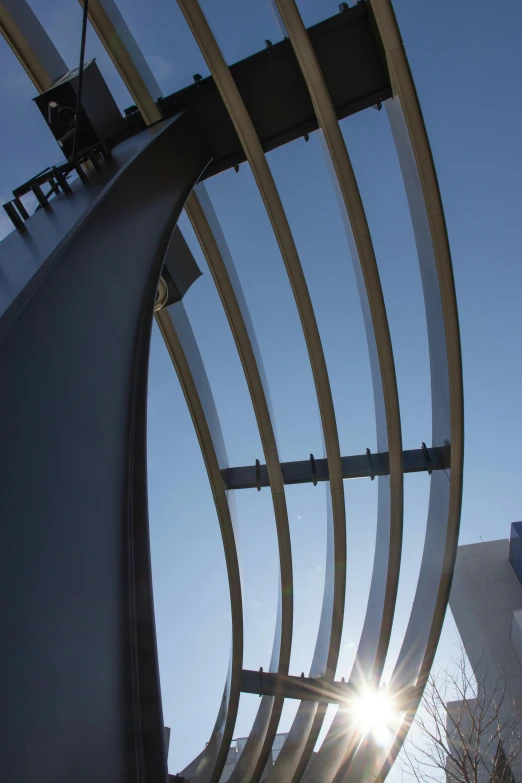 a very tall structure with some big metal pieces hanging from it's sides