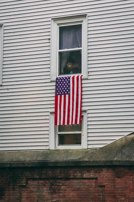an american flag is hanging out of the window