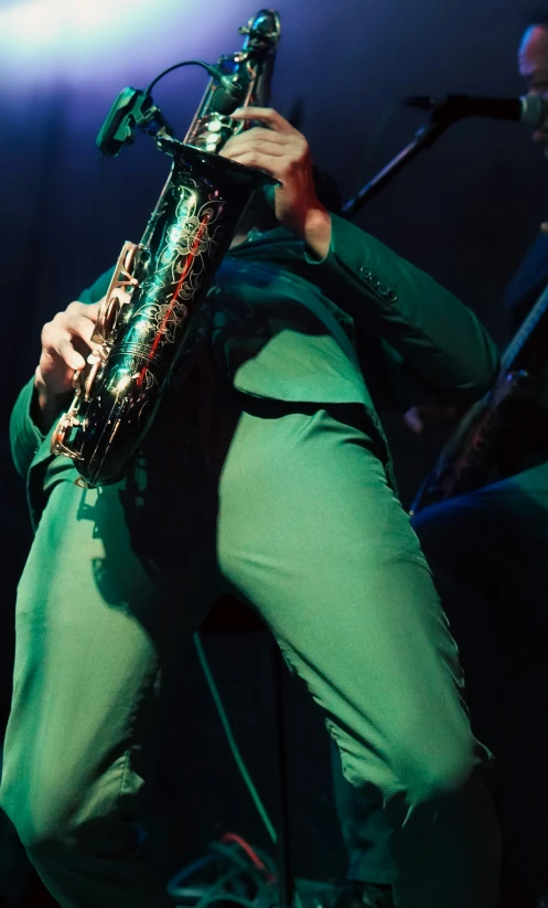 a person playing a saxophone on stage at night