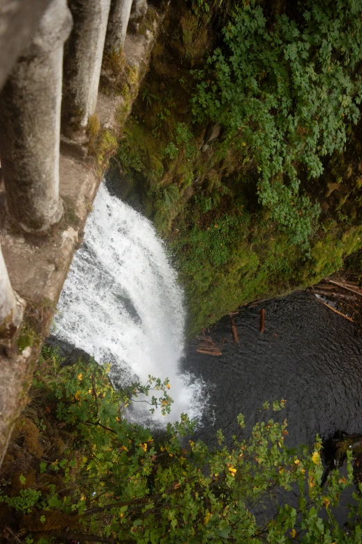 an aerial view of a waterfall in a valley