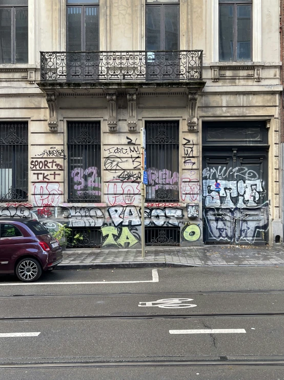 a small car is parked in front of a building