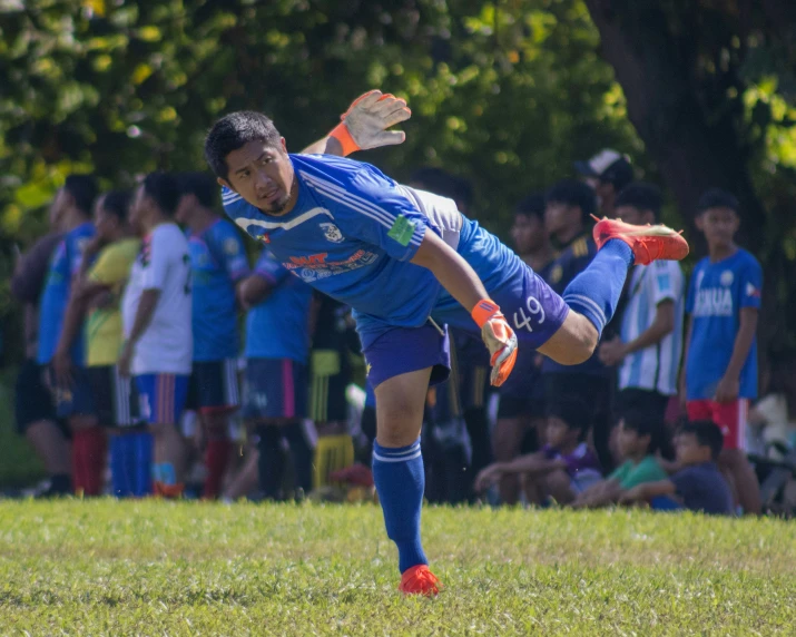 a man kicking the ball with his legs