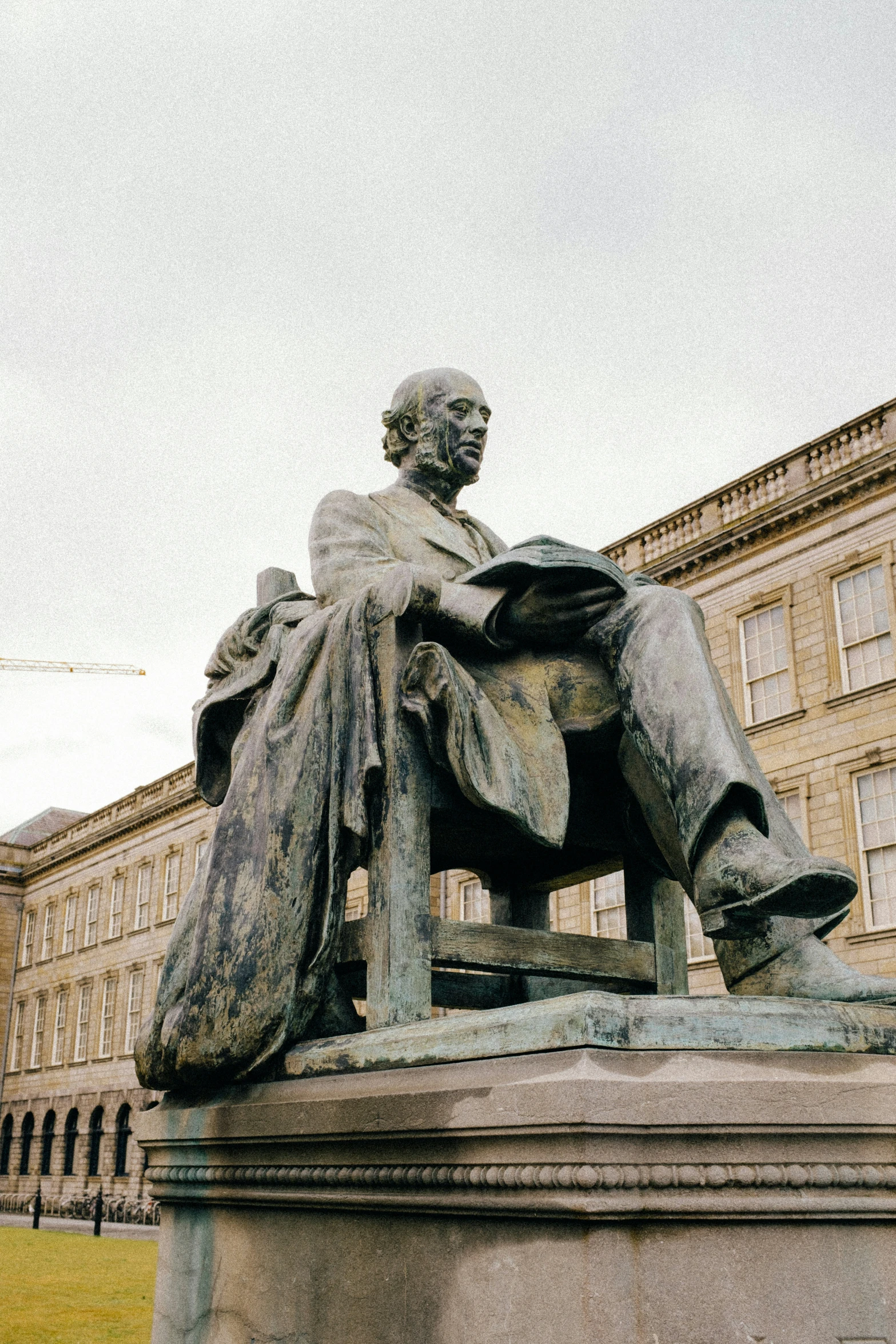 an old statue sitting outside with a liry in the background