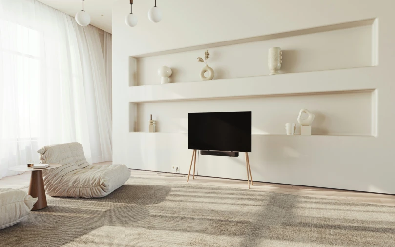 a living room with a sofa, tv and shelves