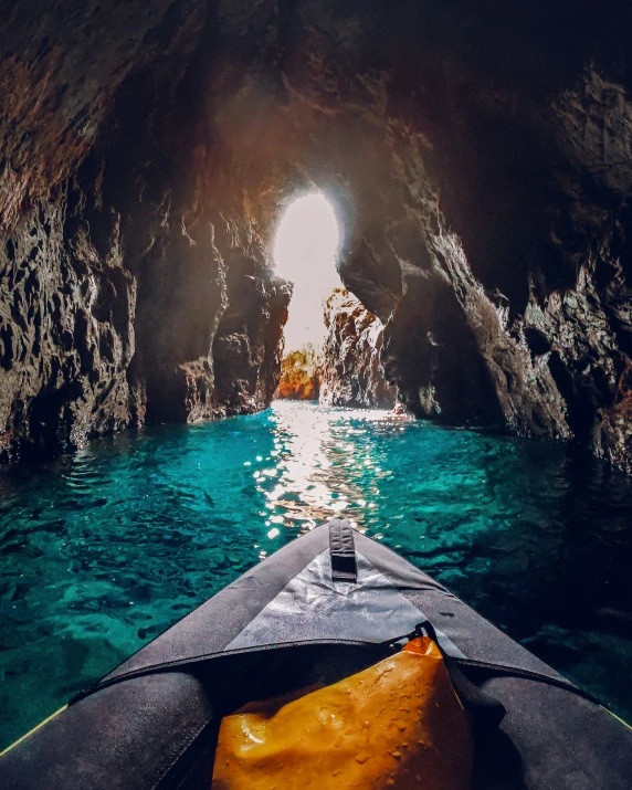 there is a view from a kayak into a cave