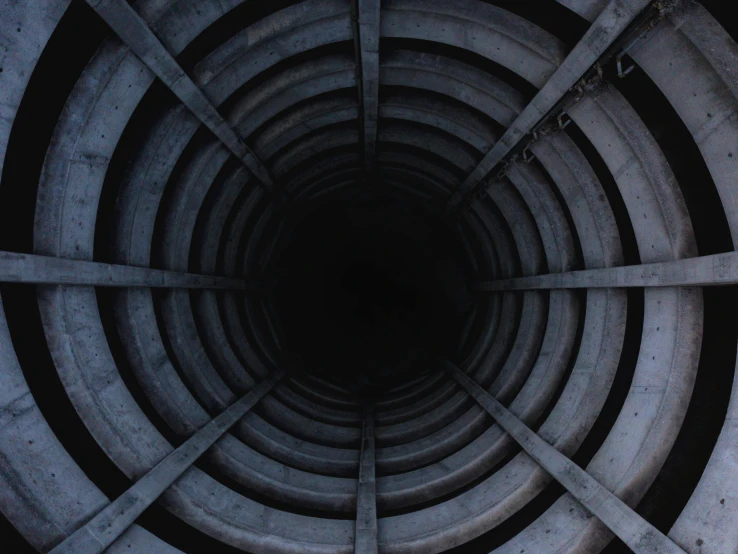 the inside of a sewer hole with metal bars