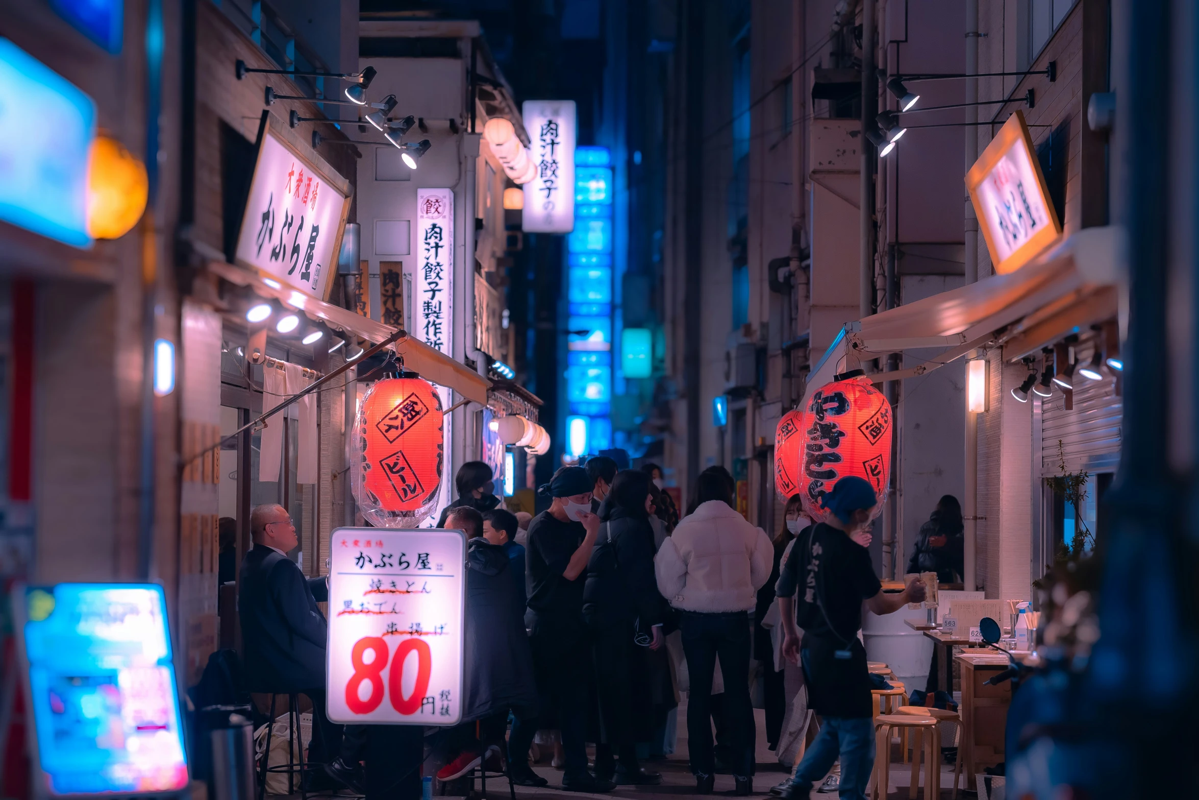 a group of people standing around a restaurant