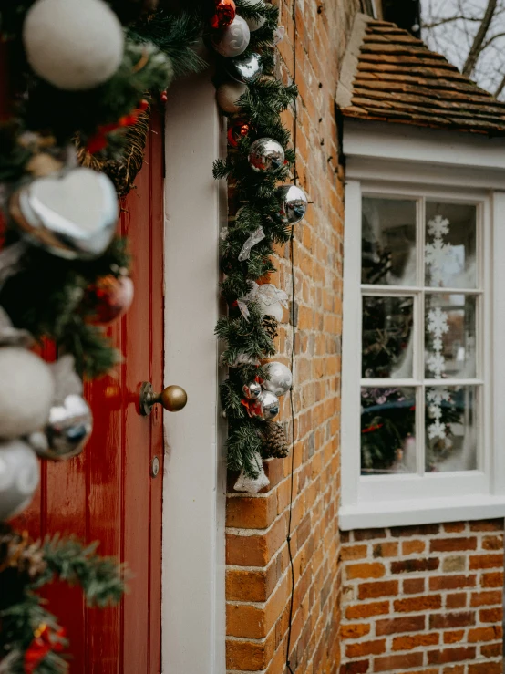 a house decorated for christmas with garland on it