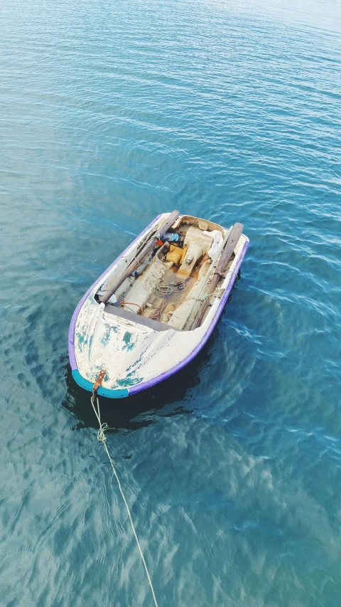 a small boat tied up on a calm lake