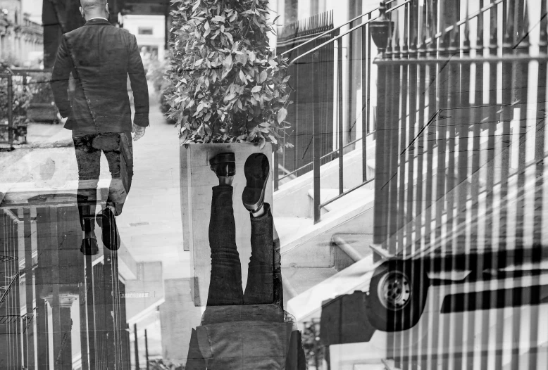 a reflection of a man walking in the street with luggage