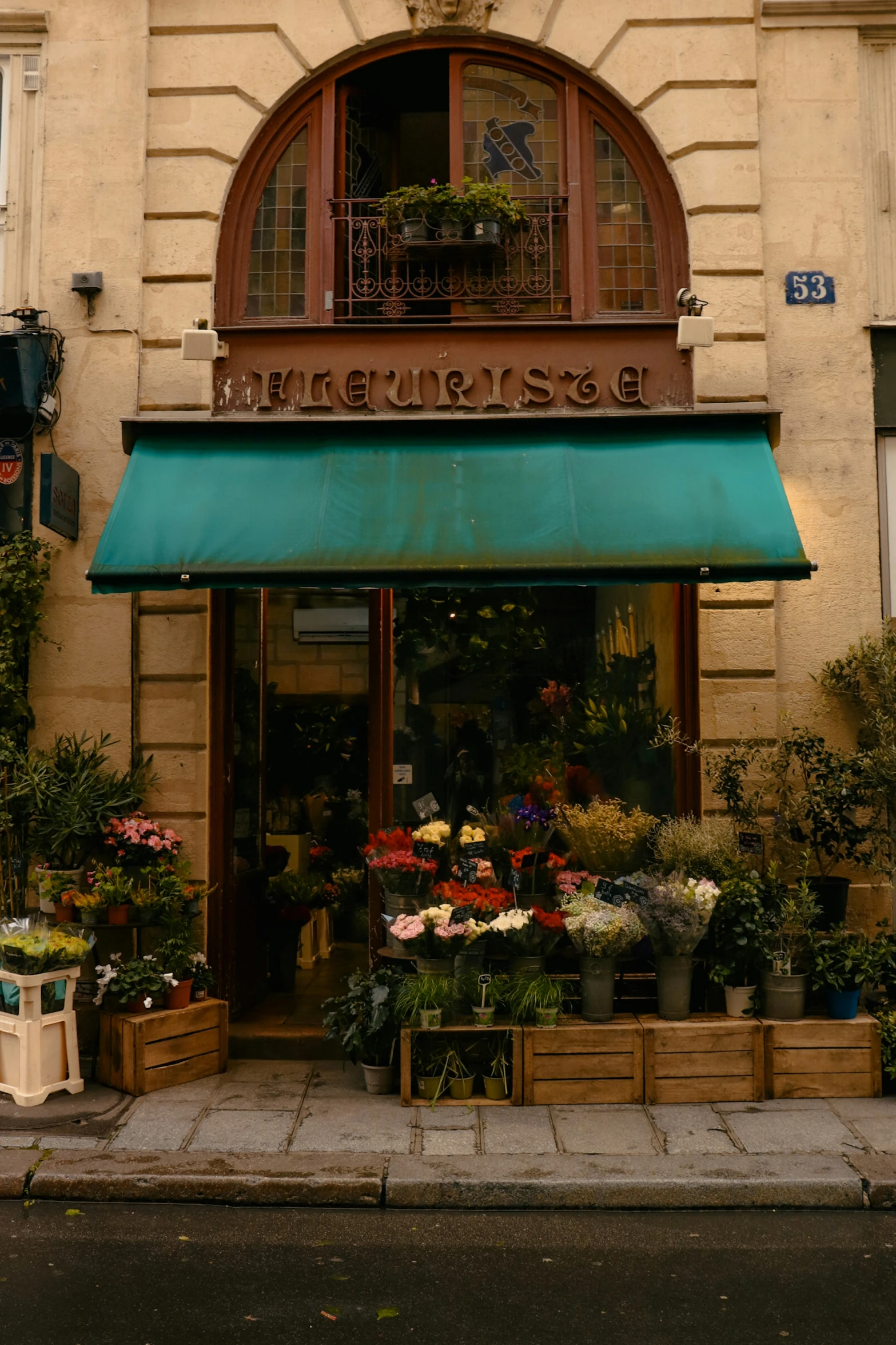 a building with flowers outside it and outside awning