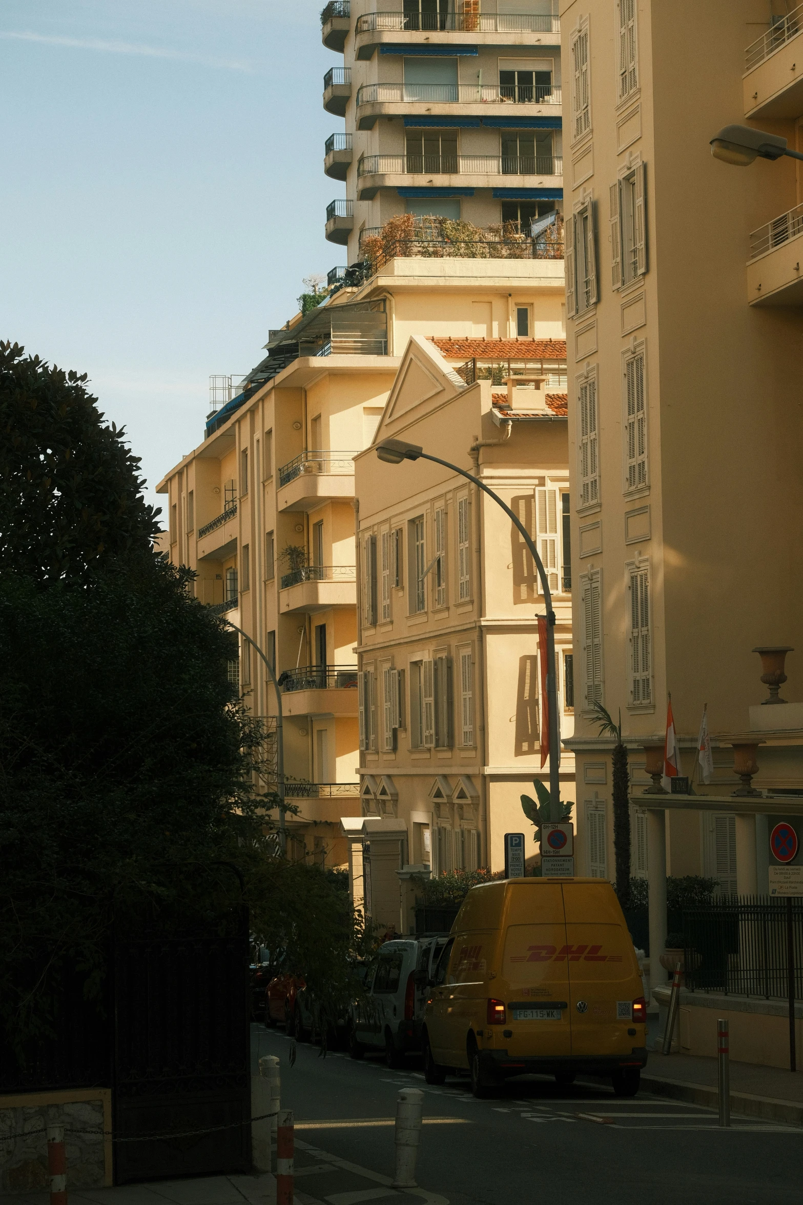 the view of a street corner in front of many apartment buildings